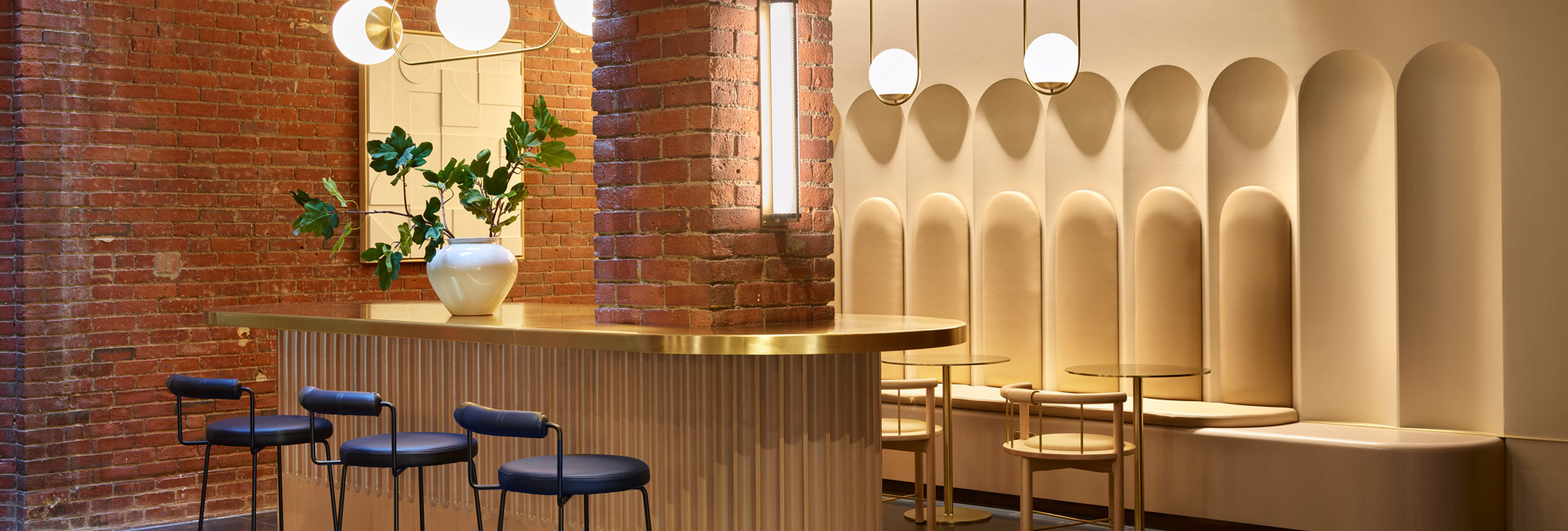 A bar with a gold bar and chairs, creating an elegant and inviting atmosphere for patrons to relax.