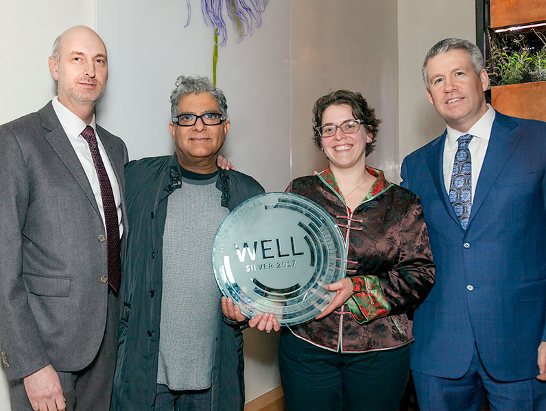 (L to R): Rob Leon, Dr. Deepak Chopra, Jennifer Taranto and Jim Donaghy, accepting the WELL certification plaque.