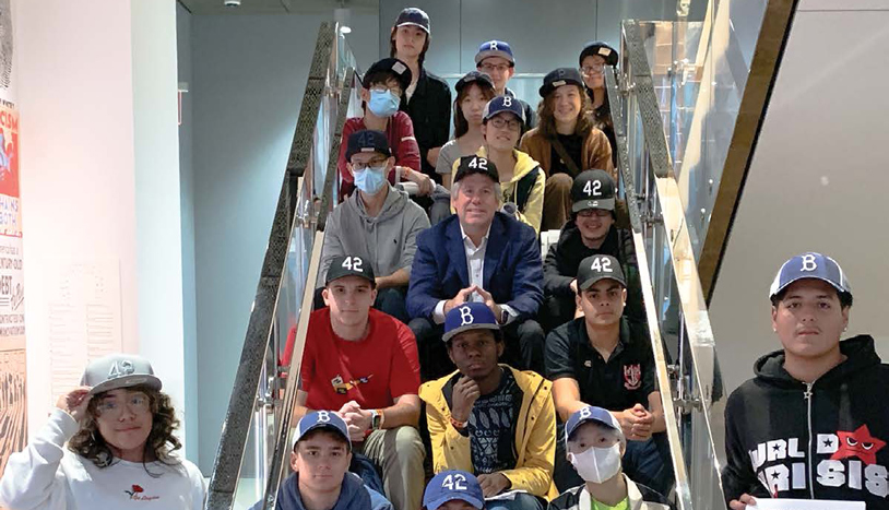 Jim Donaghy posing for photo with teens at museum
