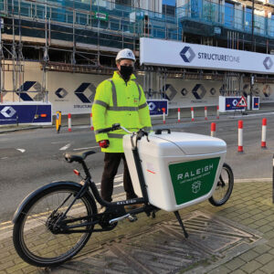 Structure Tone employee  standing with one of their Cargo bikes