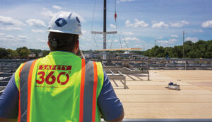 Structure Tone construction worker looks out at the progress of the new L'Oreal research & innovation center.