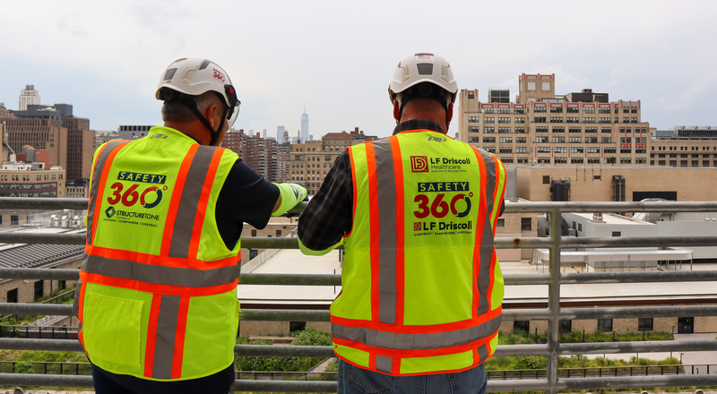 Construction workers in full PPE viewing NYC skyline