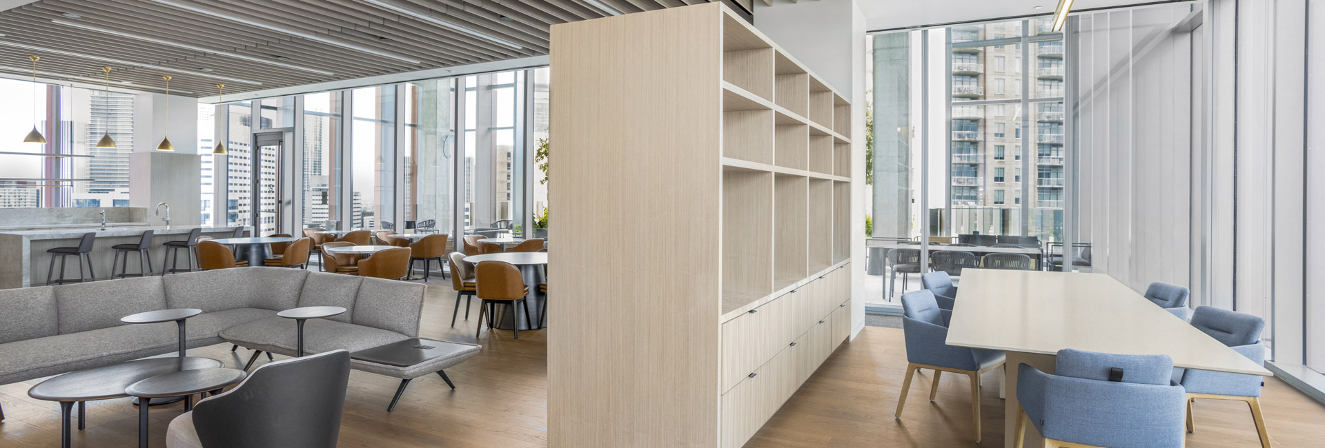 An updated office environment with a generous table and several chairs, promoting a collaborative workspace for employees.