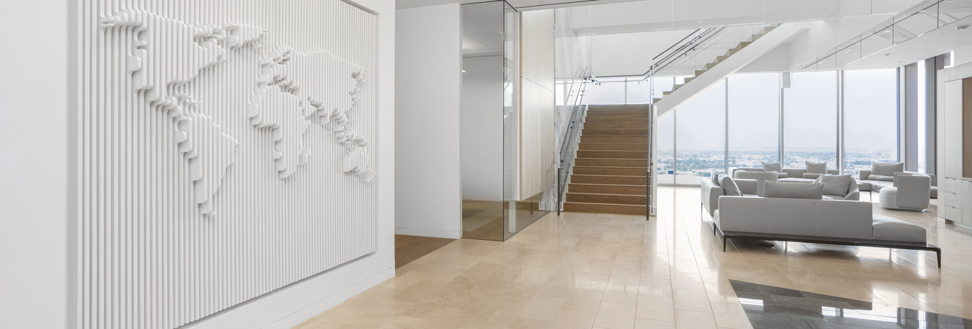 A spacious hallway featuring a large white wall adorned with a prominent map.