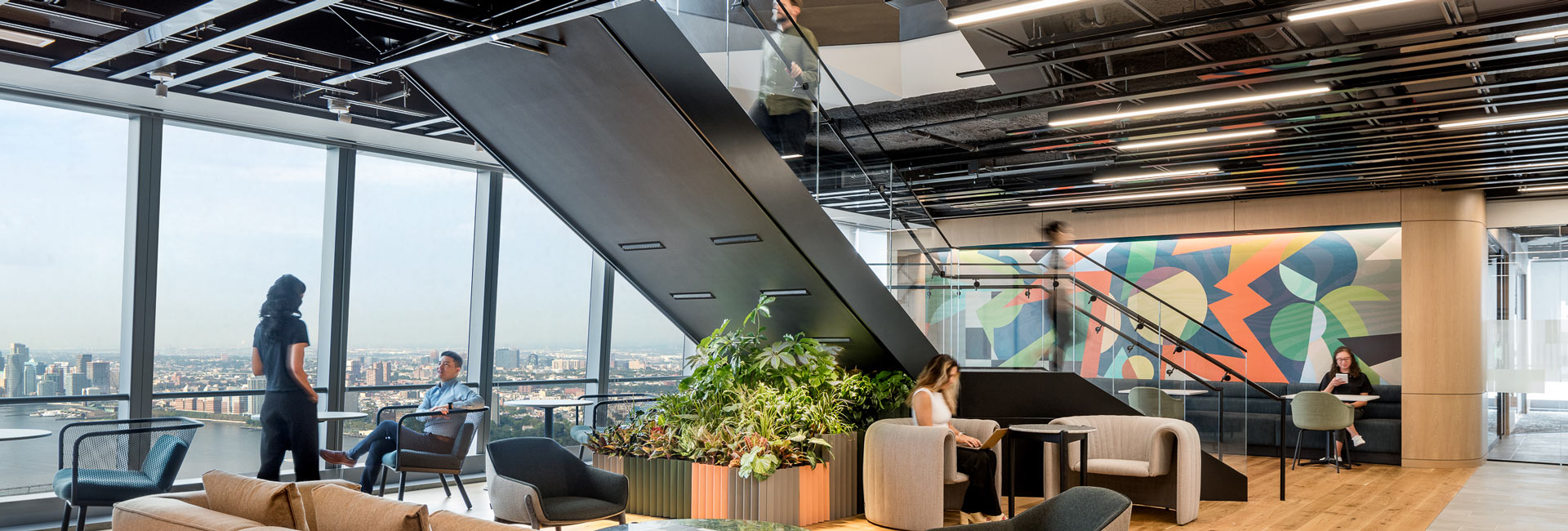 An open office area with a featured staircase in the middle