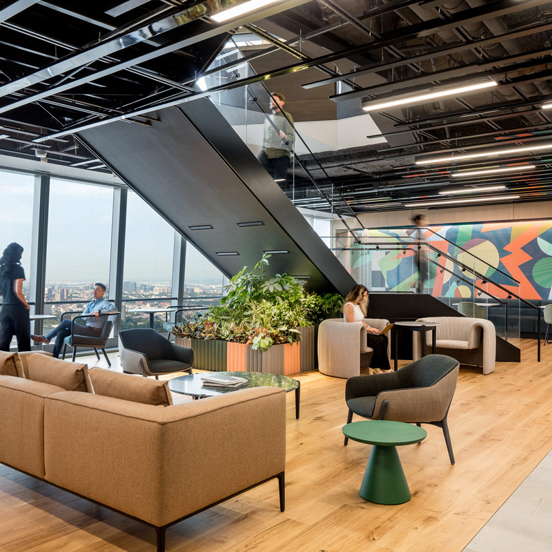 An open office area with a featured staircase in the middle
