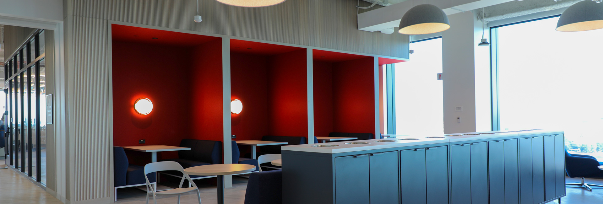 Open area with booths and extra seating for employees to collaborate.