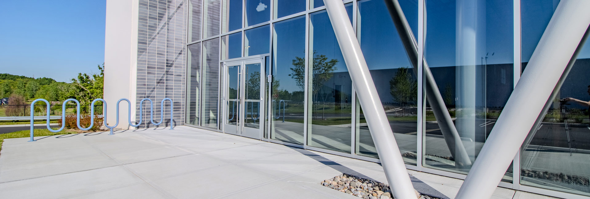 Front entrance with floor to ceiling windows at a warehouse center.