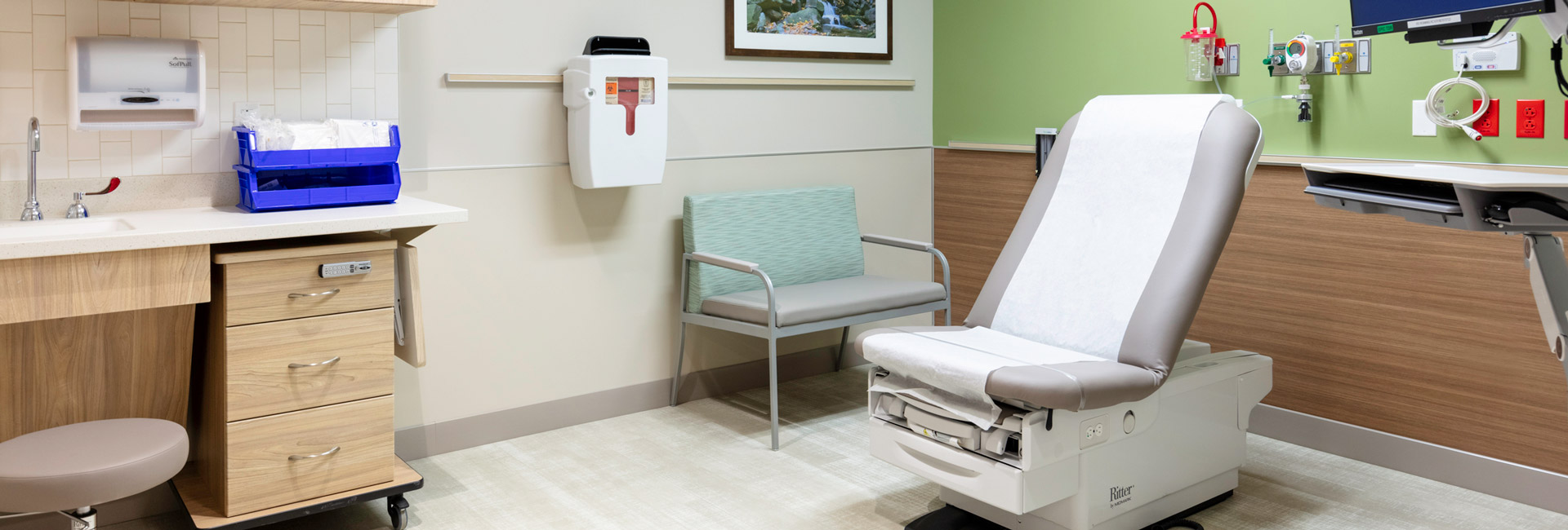 Patient room with exam table and chair.