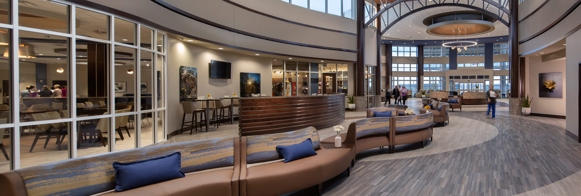 Reception area with a long couch through the lobby.