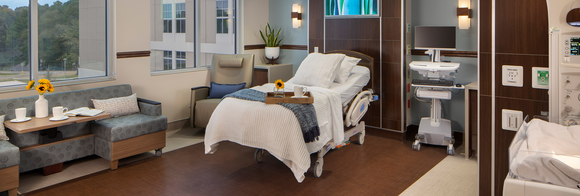 Patient room with a bed and chair at North Alabama Medical Center