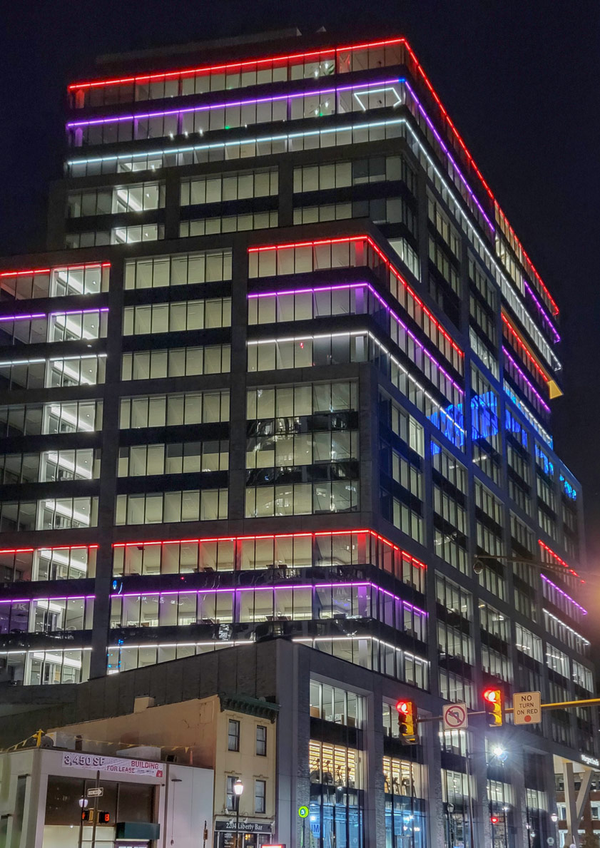 Exterior view of Morgan Lewis building with red, purple, white lights surrounding the building