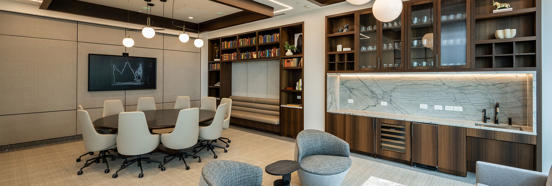 Meeting room with tables and chairs, bar area, and TV