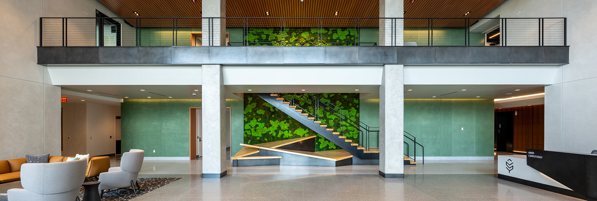 Central staircase from the lobby with greenery on the wall.