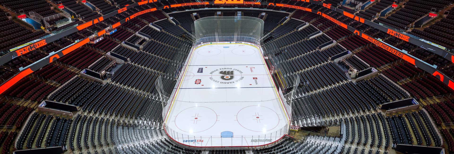 Birdseye view of an empty stadium overlooking the ice rink.