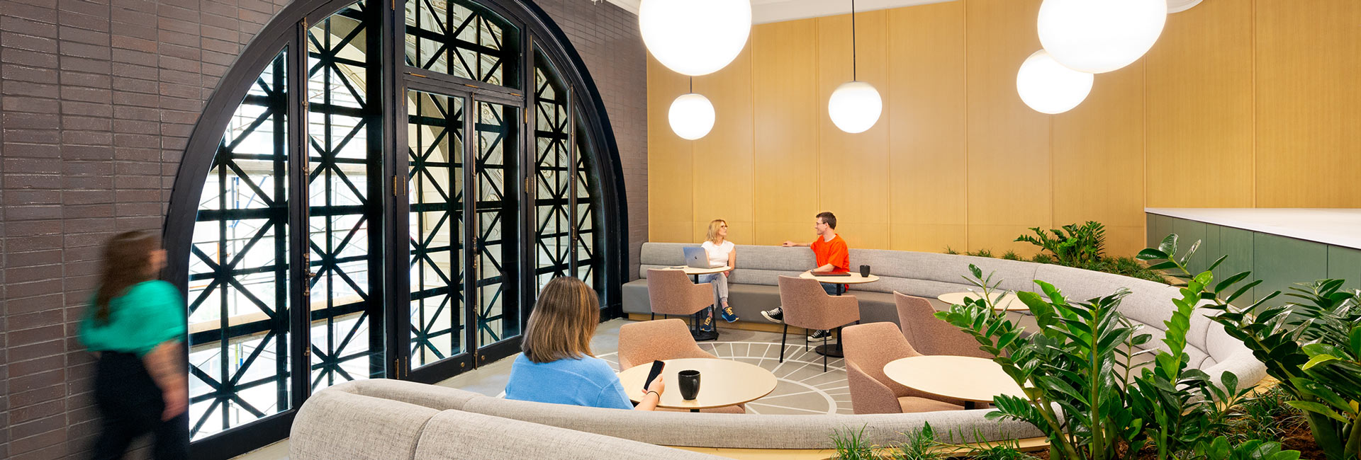 Tables and chairs next to a large feature window