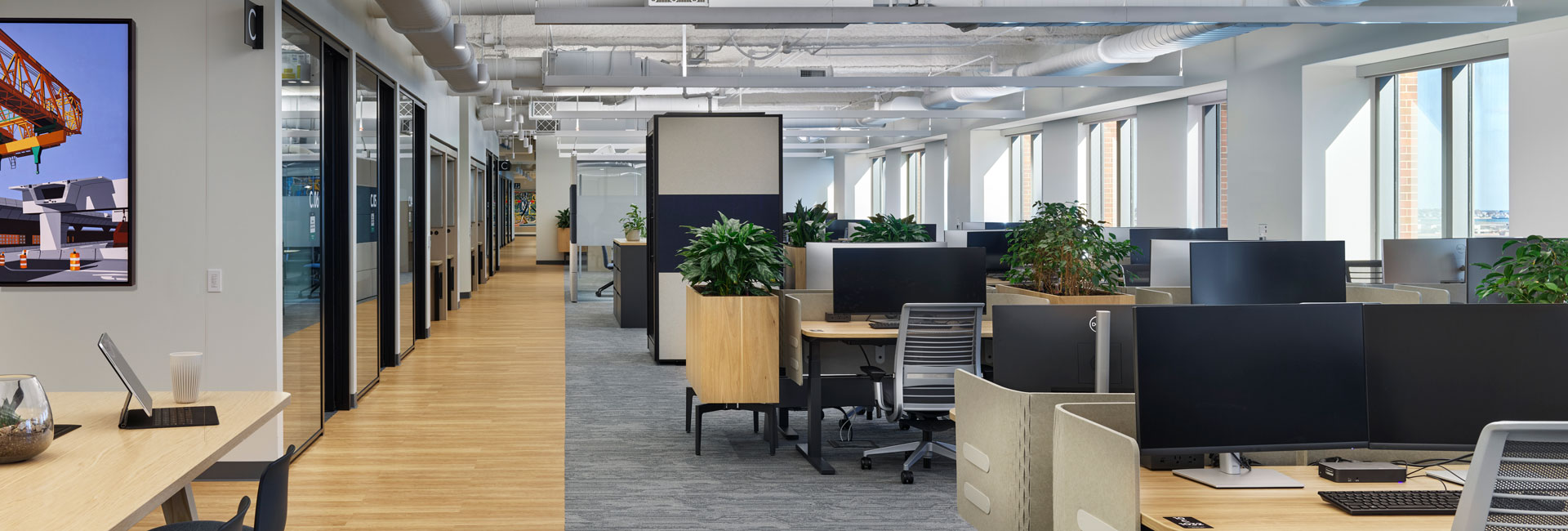 An office environment showcasing several desks for employees to sit and work.