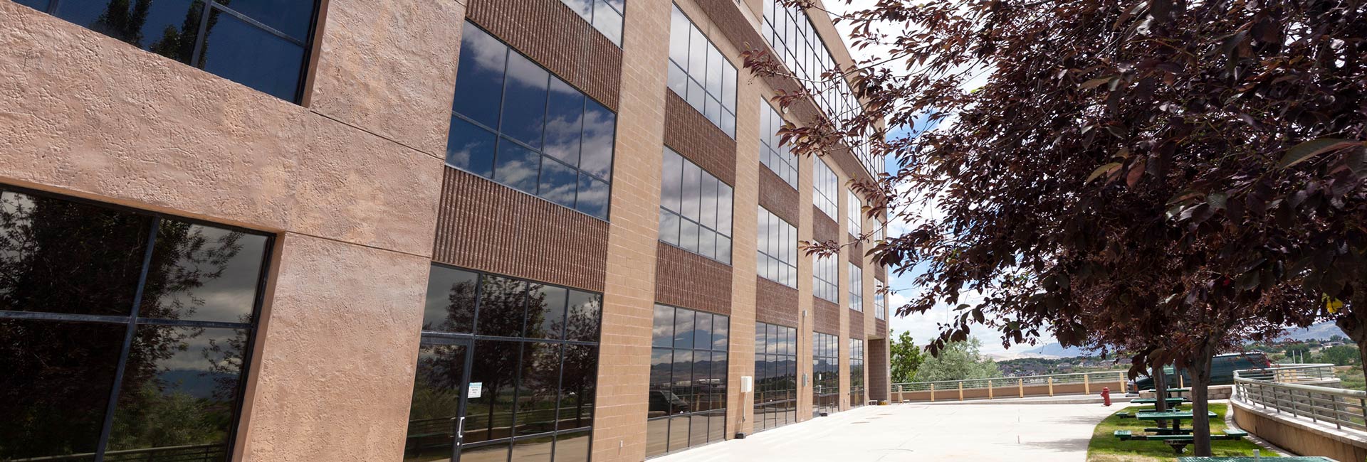 A large building featuring numerous windows, showcasing its expansive and modern architectural design.