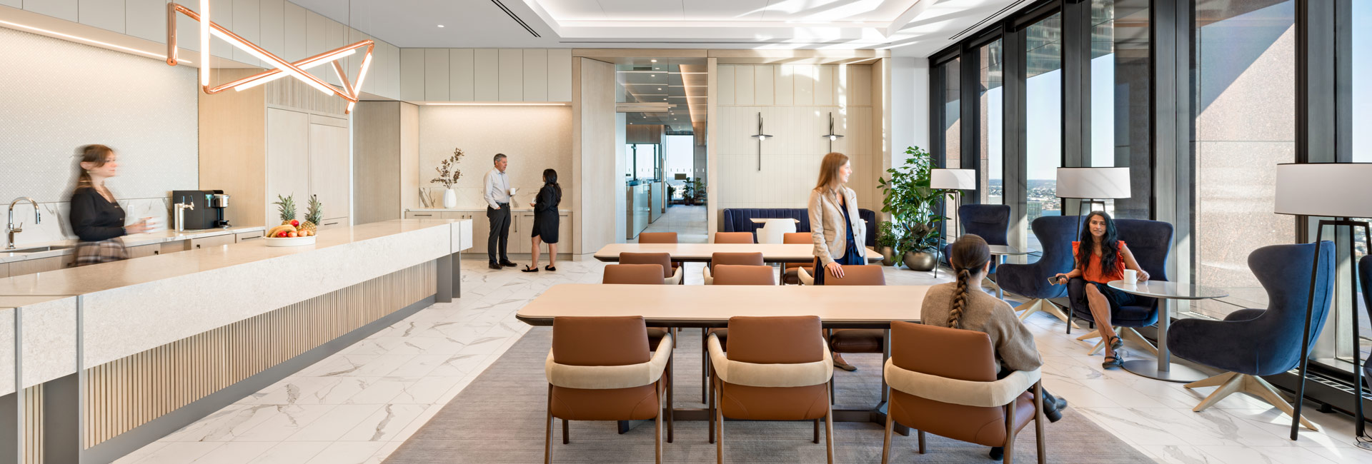 A modern kitchen area featuring a spacious area with a large window allowing natural light to illuminate the space.
