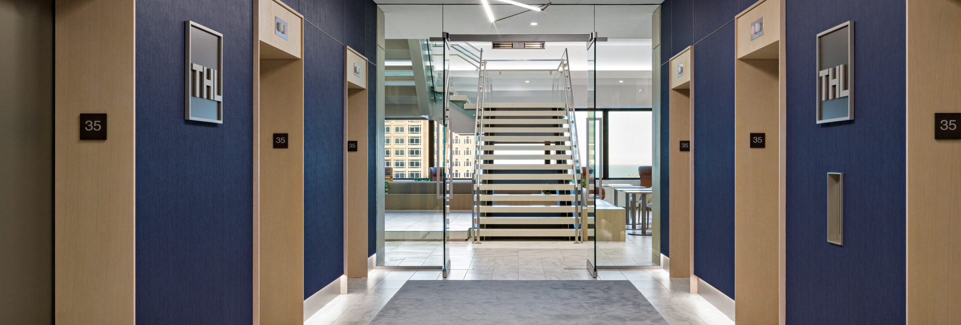 A hallway featuring blue walls and a matching blue carpet, creating a cohesive and calming atmosphere.