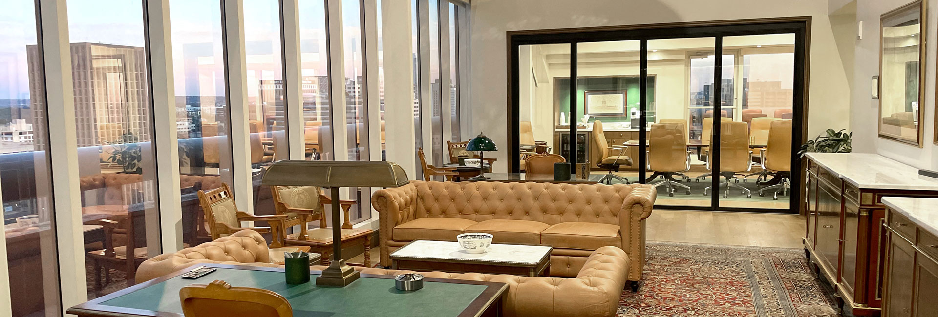 A spacious open area in the law office featuring a large window that offers a panoramic view of the city skyline.