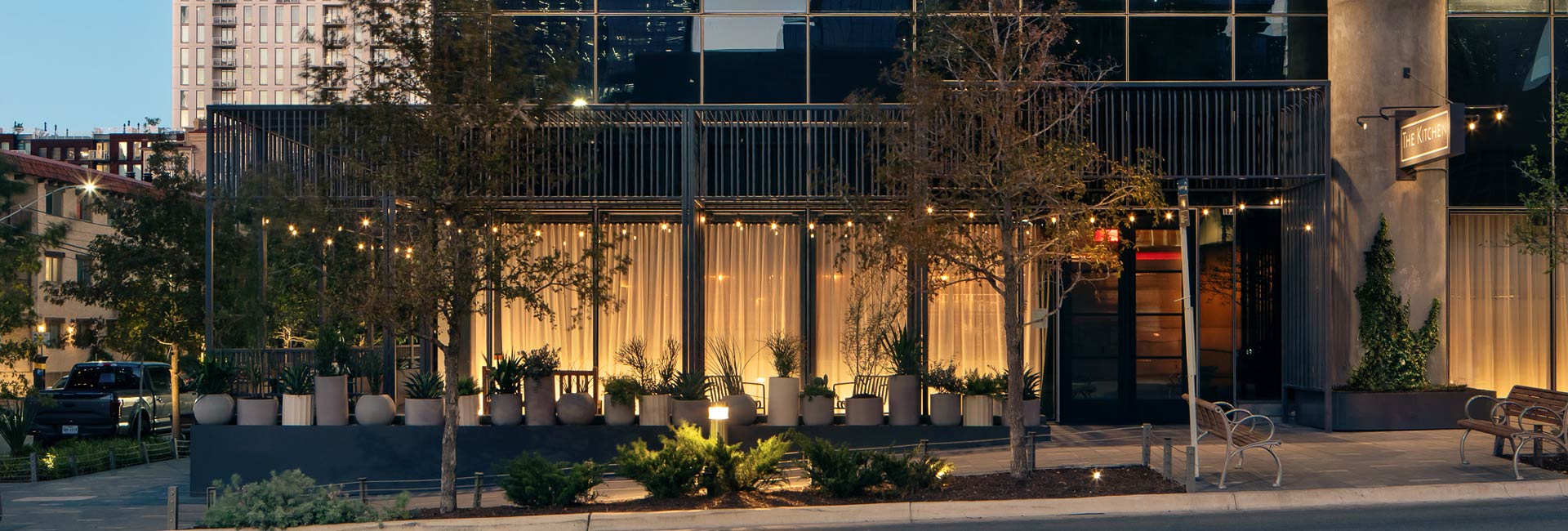 A building's facade is prominently displayed, accompanied by a street light illuminating the entrance.