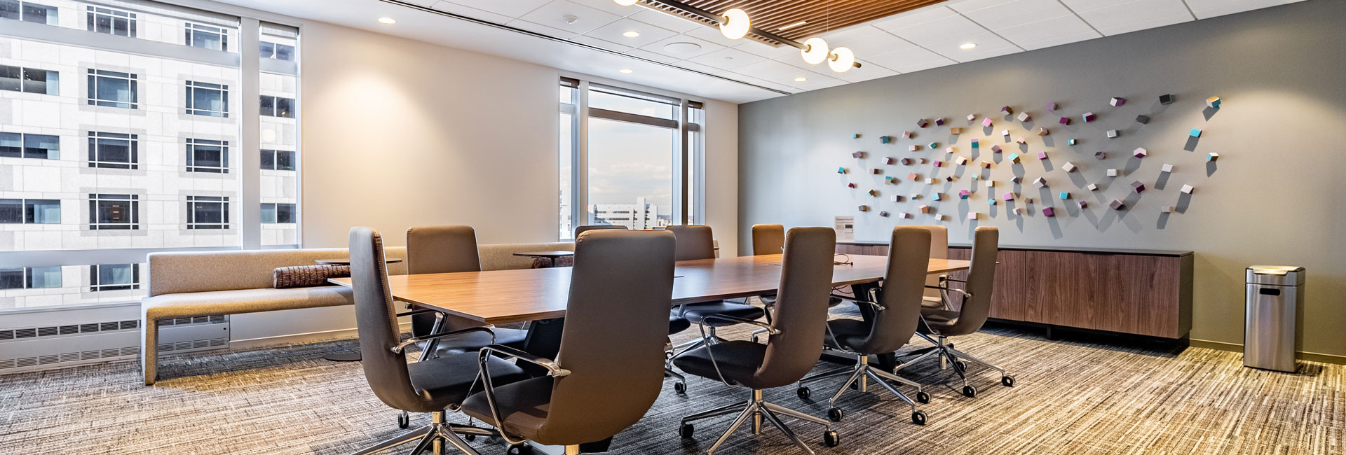 A conference room featuring a large table surrounded by several chairs, designed for meetings and discussions.