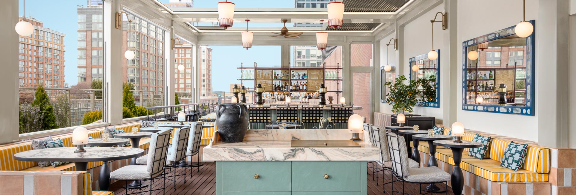 Rooftop terrace at a New York hotel, featuring city skyline views and outdoor seating for guests to enjoy.