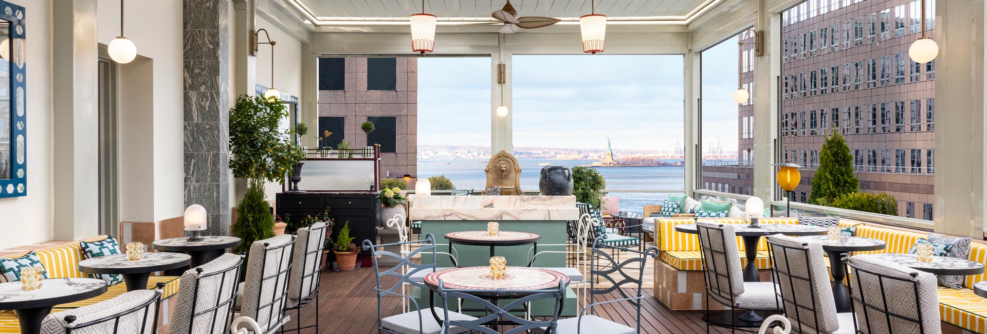 Rooftop terrace at a New York hotel, featuring city skyline views and outdoor seating for guests to enjoy.