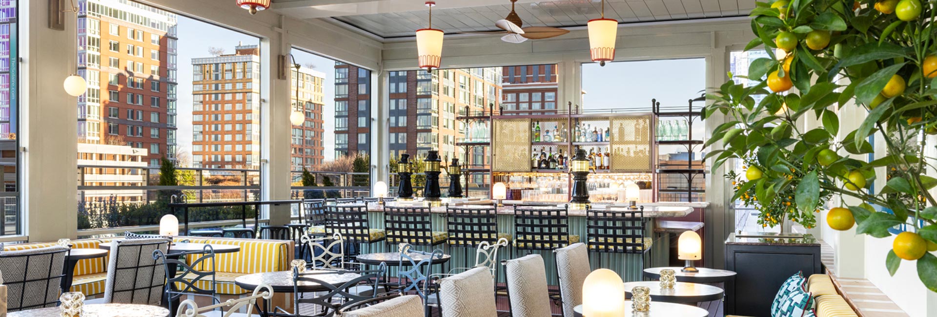 Rooftop terrace at a New York hotel, featuring city skyline views and outdoor seating for guests to enjoy.