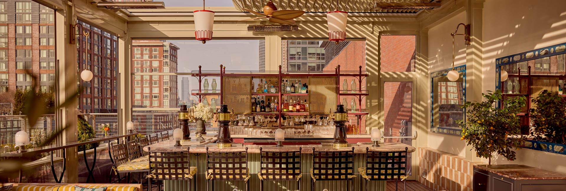 Rooftop terrace at a New York hotel, featuring city skyline views and outdoor seating for guests to enjoy.