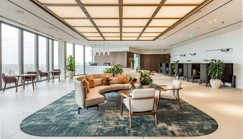 Open office area with couch and chairs for employees to use and collaborate.
