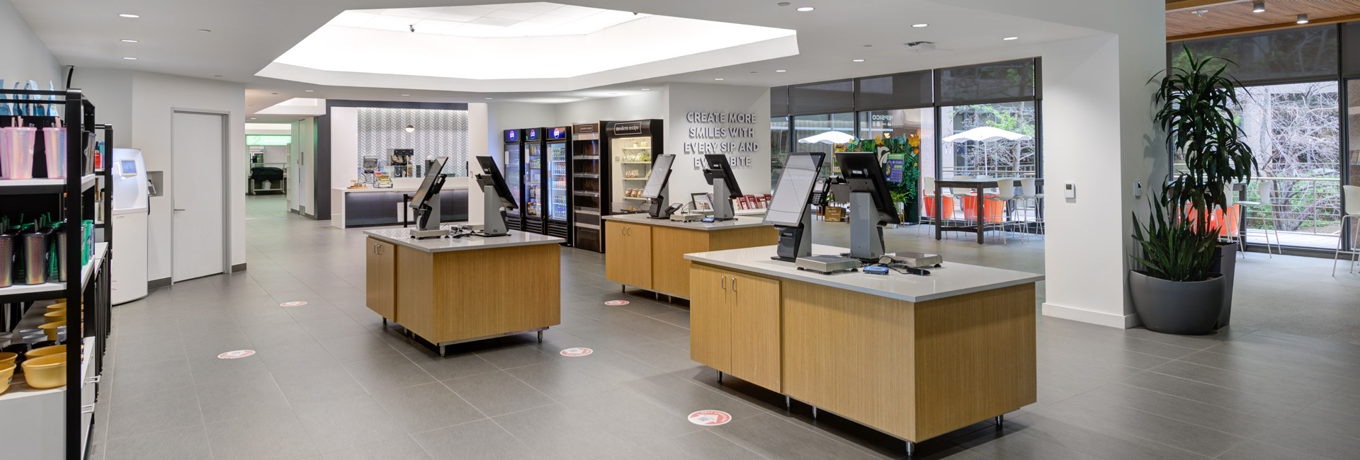 A cafeteria interior featuring a large counter and a sink, designed for customer service and product display.