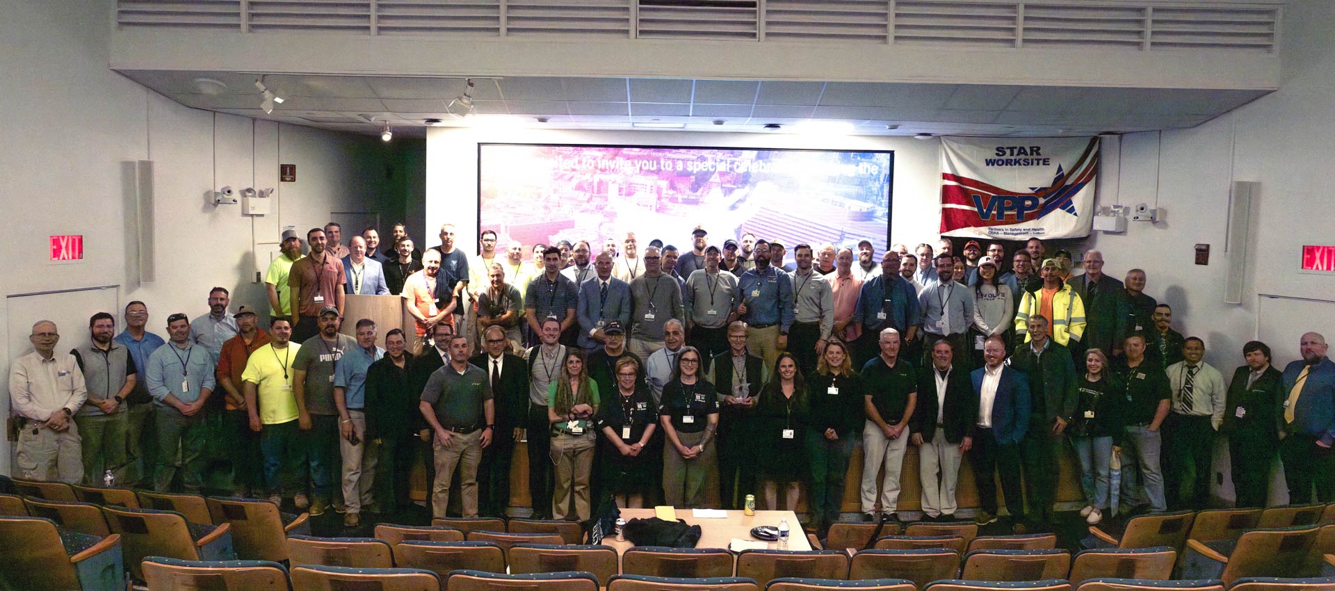 A group photo in an auditorium