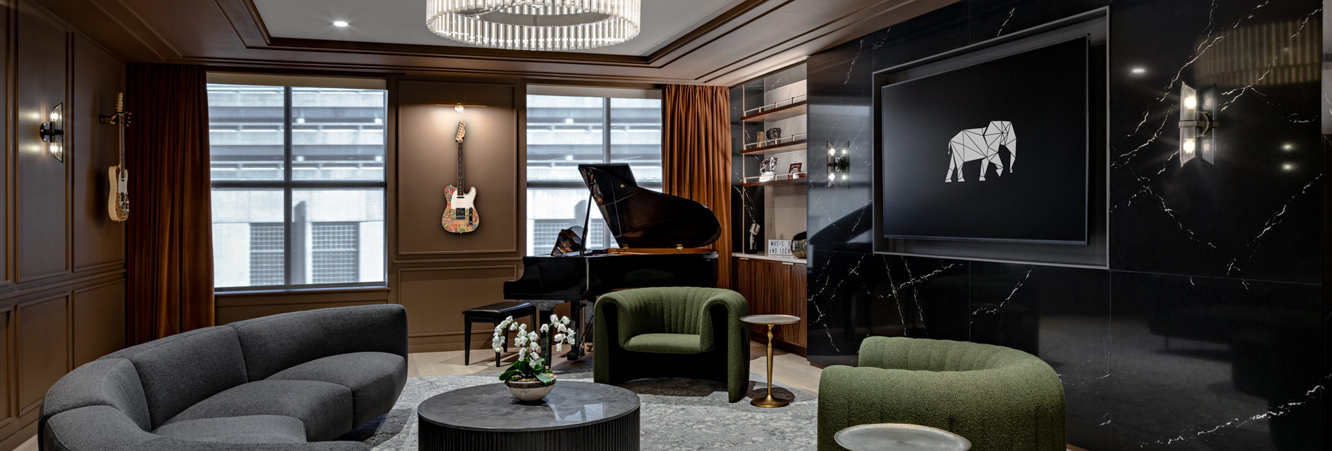 A stylish room with a grand piano, comfortable chairs, and an artistic painting displayed prominently.