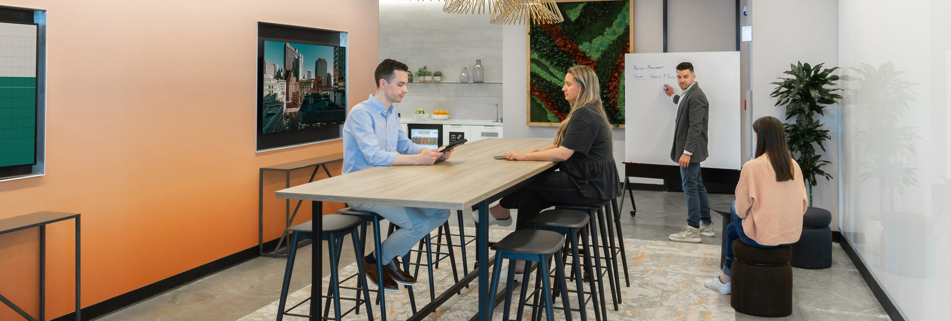 A conference room featuring individuals gathered at a table, actively participating in a meeting.