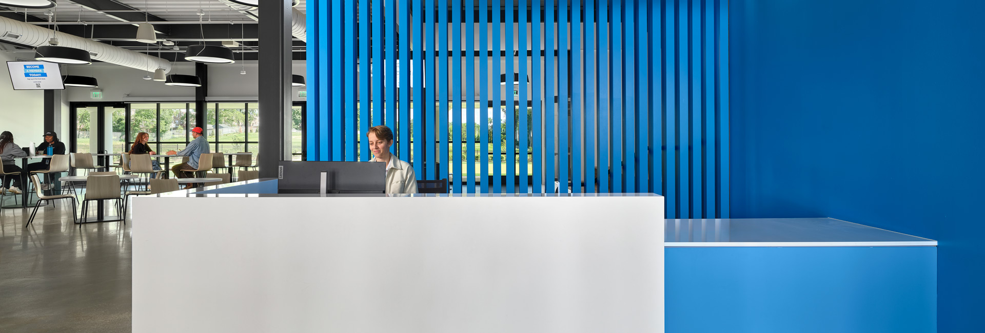 A blue and white reception desk in a modern office setting, featuring a sleek design and organized workspace.