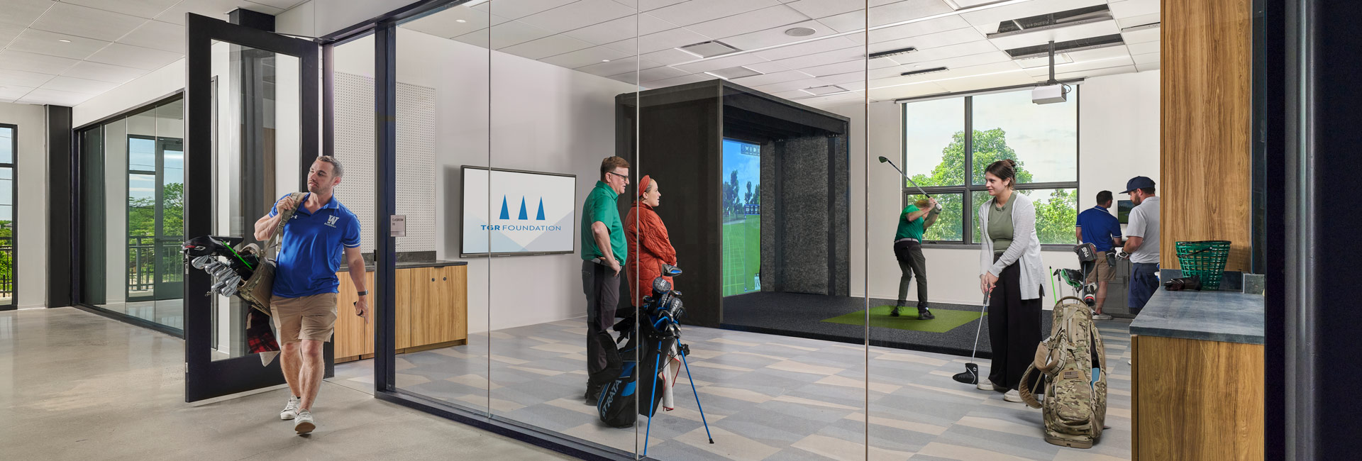 A modern golf simulator room featuring high-tech screens and golf equipment at the new golf club.