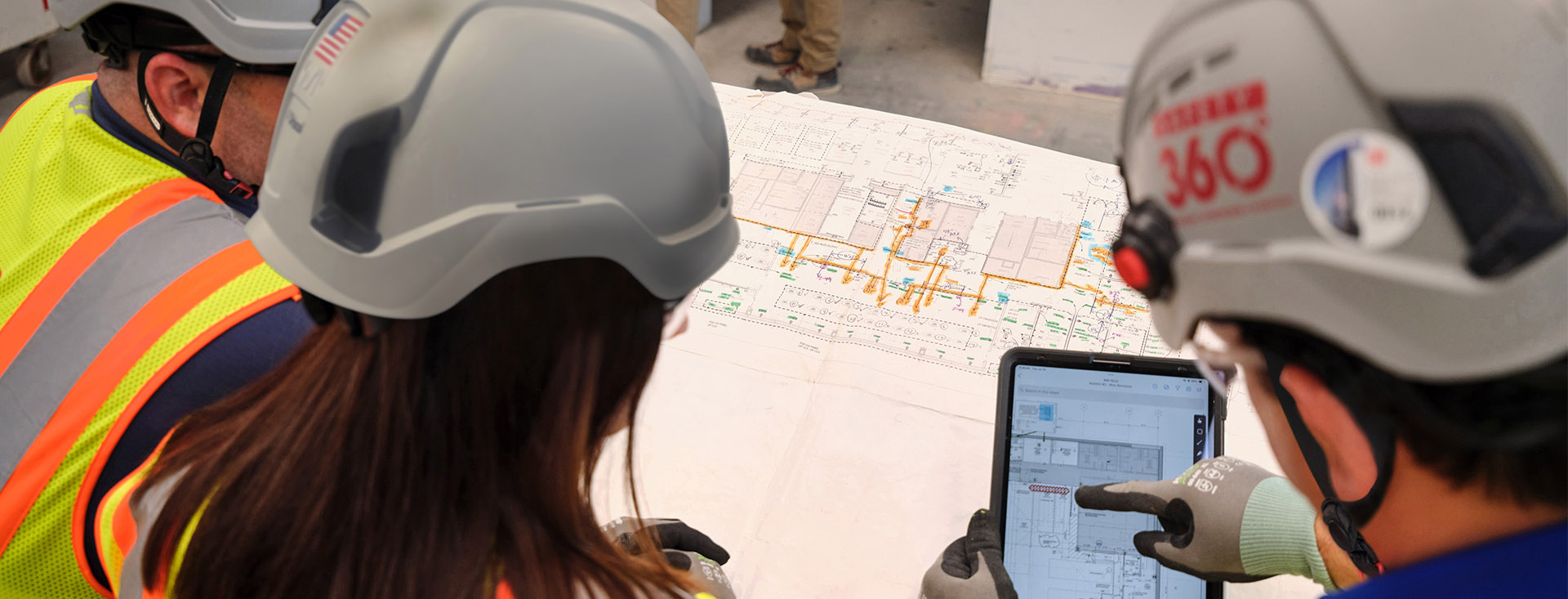 LFD workers looking at blueprints