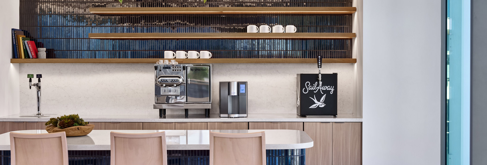 A kitchen featuring a coffee maker on the counter and a shelf filled with various kitchen items.