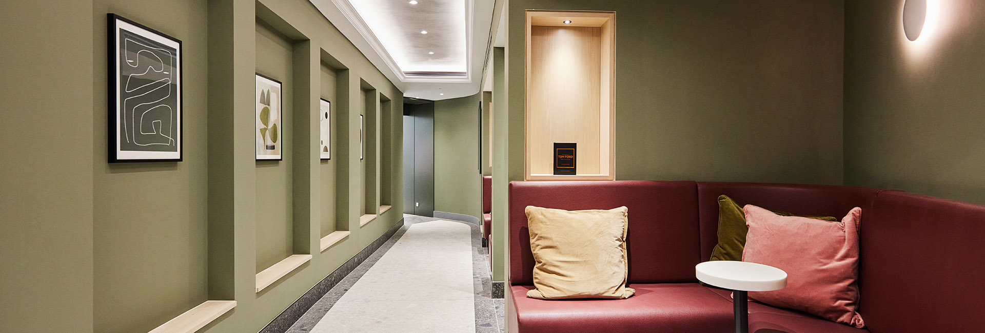 green hallway at the Bloomsbury Quarter with red couch nook waiting area