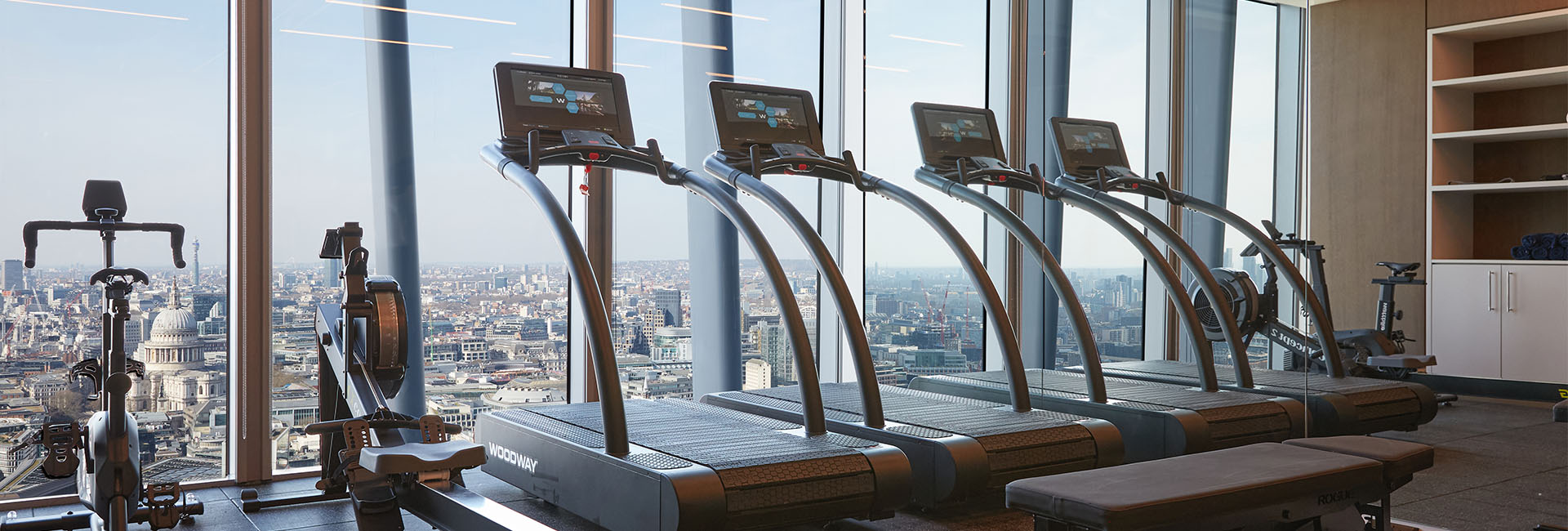 DV Trading a workout room with treadmills and a nice window view out to blue skies