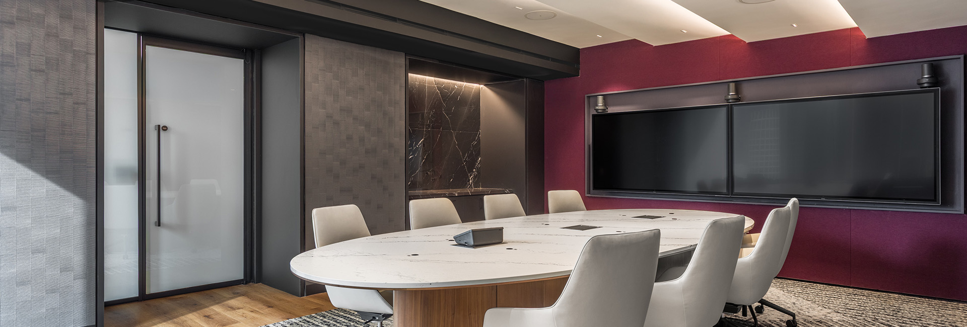 conference room with light oval table and chairs in the center