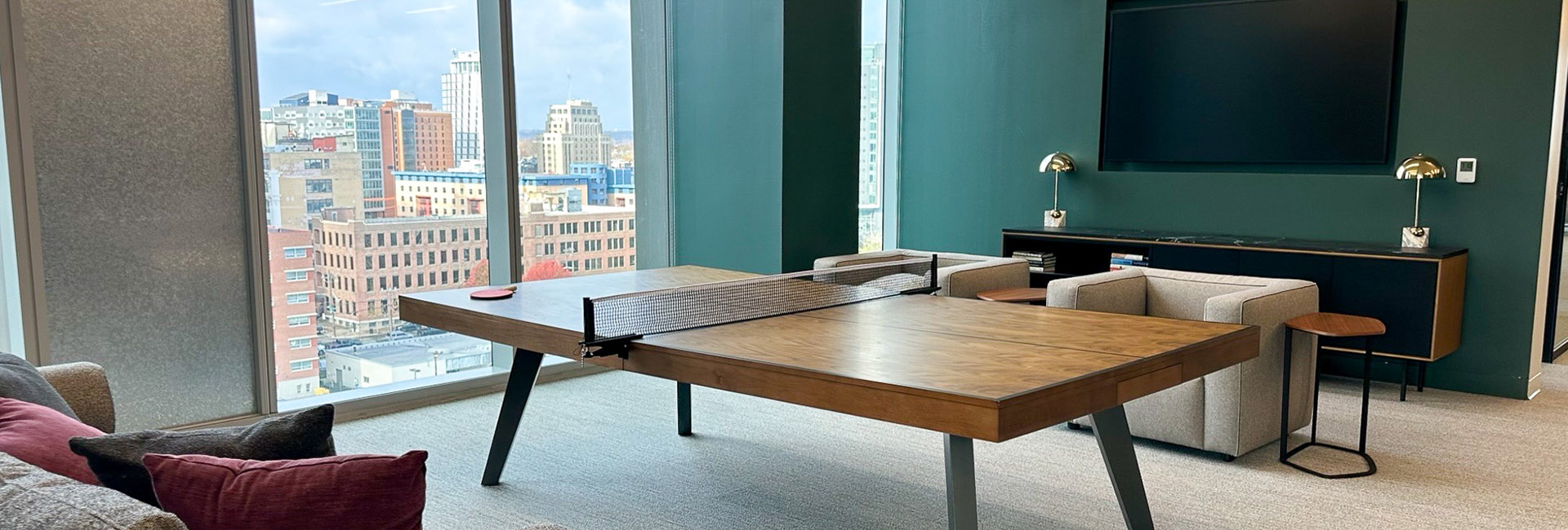 Goodwin Proctor common space with a ping pong table and seating built by Structure Tone