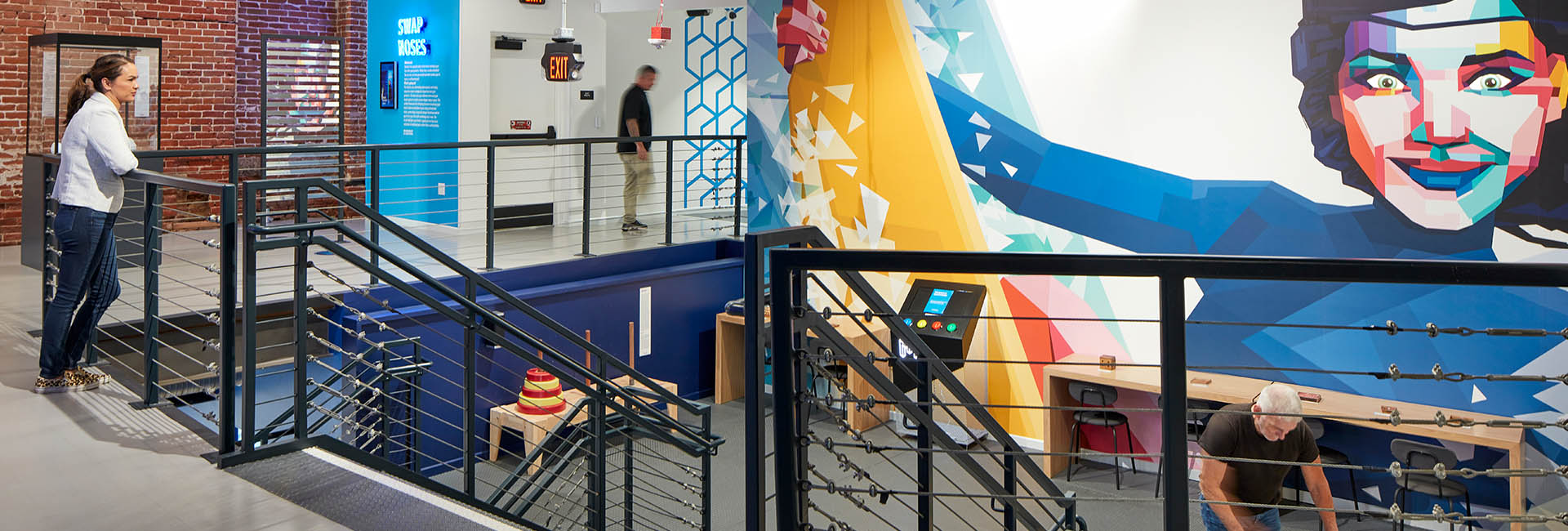 Museum Of Illusions San Diego interior image with mural and steps