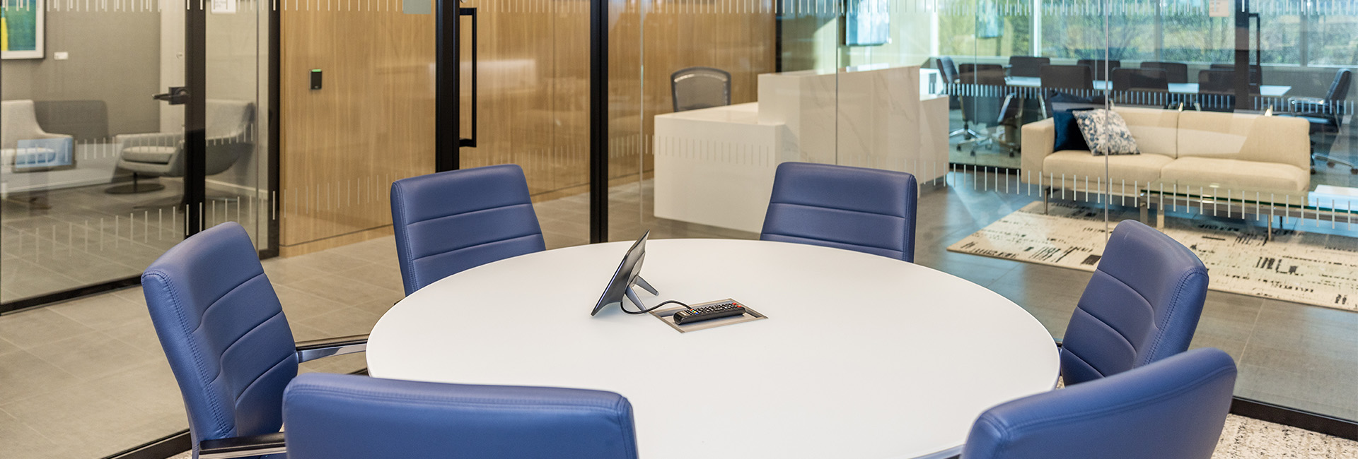 3000 Atrium Way conference room with round white table and blue chairs