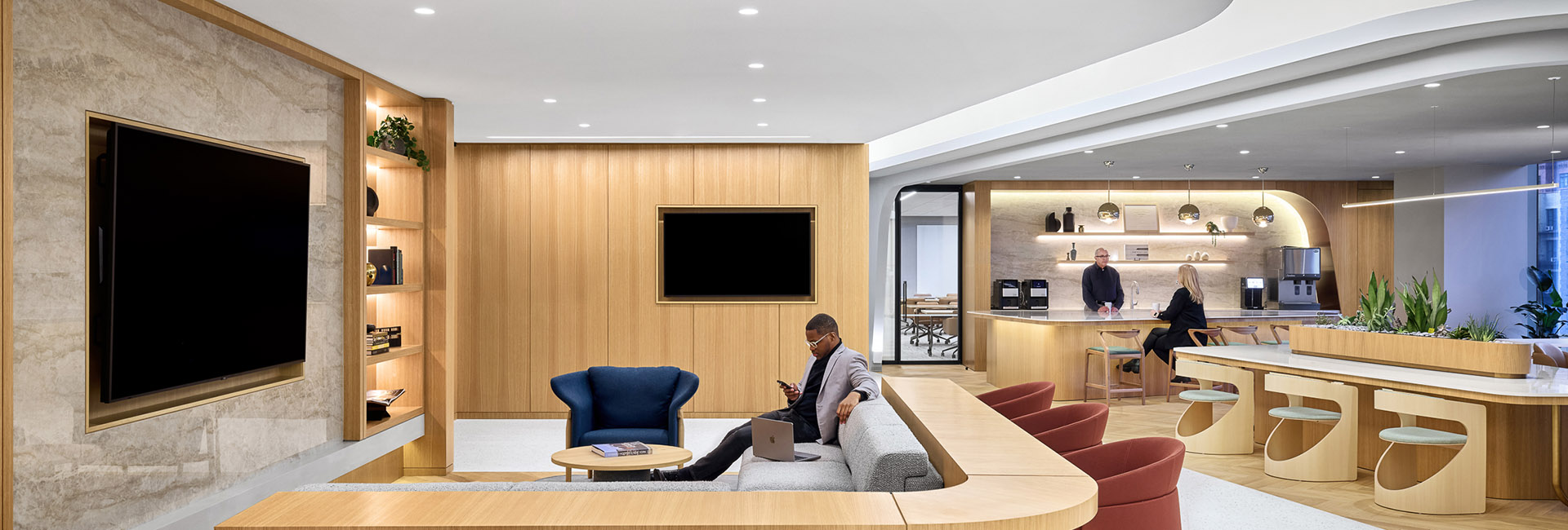 Confidential Financial Client image of lounge area with wall of wood accent and TV screen and couch area