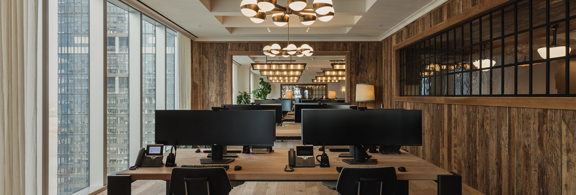 Marshall Wace workspace with wood accents throughout and wall of windows at the HQ built by Structure Tone New York