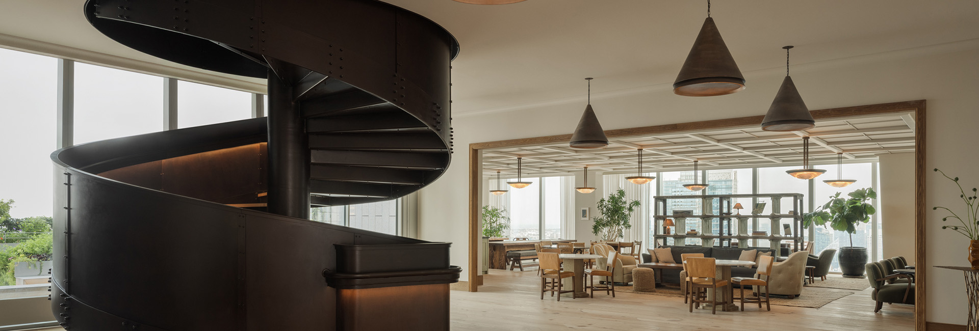 Marshall Wace lounge area with large spiral feature stair case in the center built by Structure Tone New York