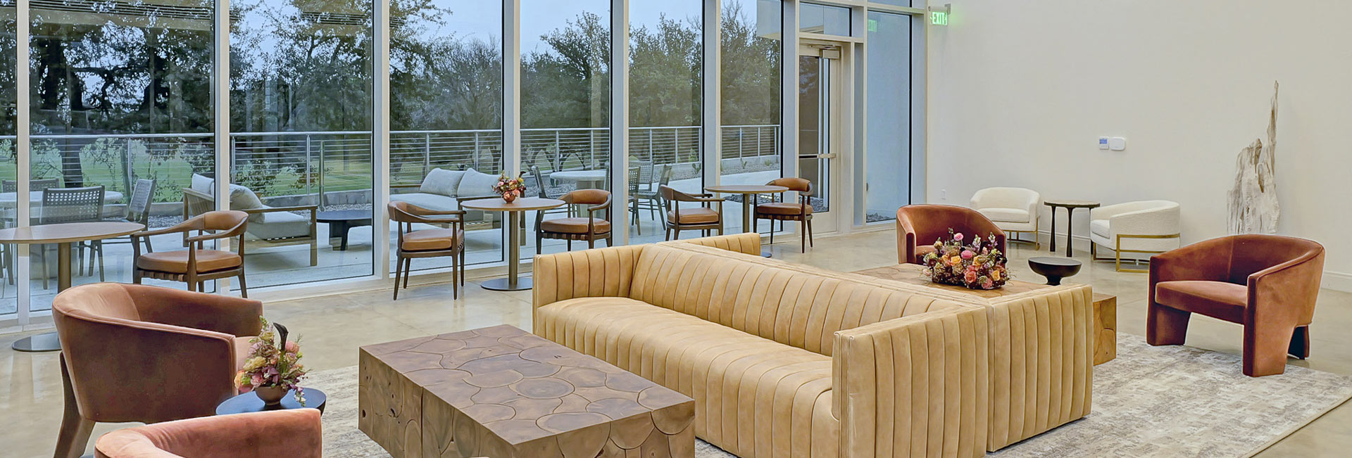 Seating area for guests next to floor to ceiling windows.